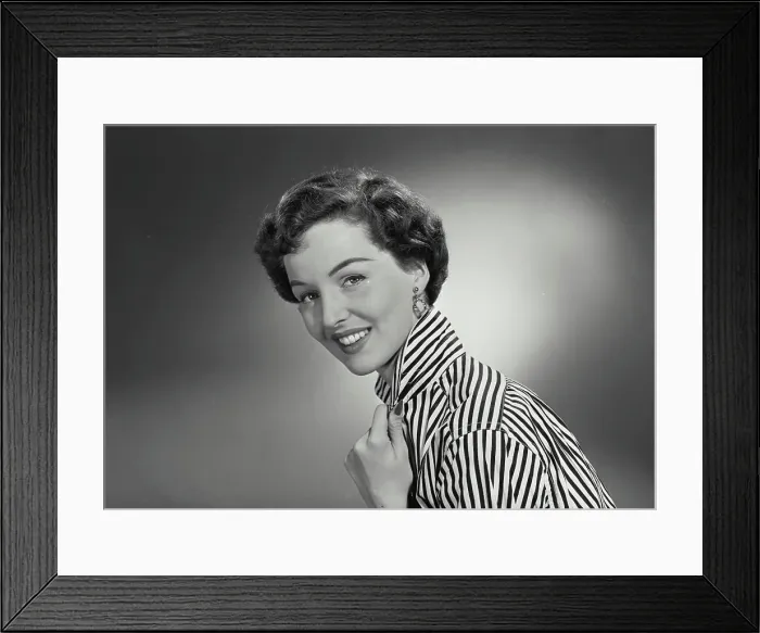 Framed Print : Vintage Photograph. Woman in striped button shirt holding collar and smiling