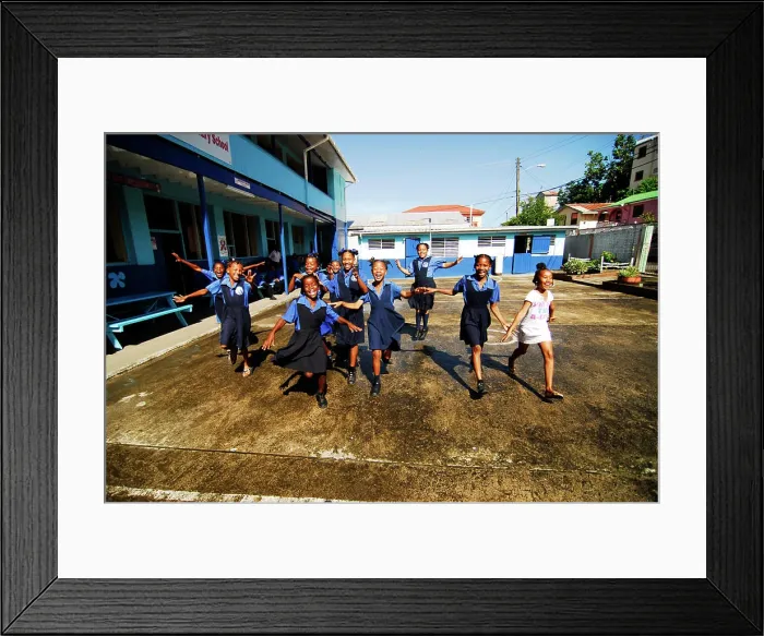 Framed Print : St Lucia, Canaries, cheerful schoolgirls running on a school ground (MR)