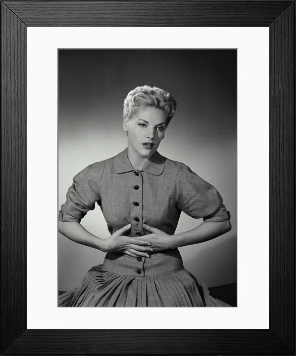 Framed Print : Vintage Photograph. Blonde woman with short hair holding hands to stomach in discomfort