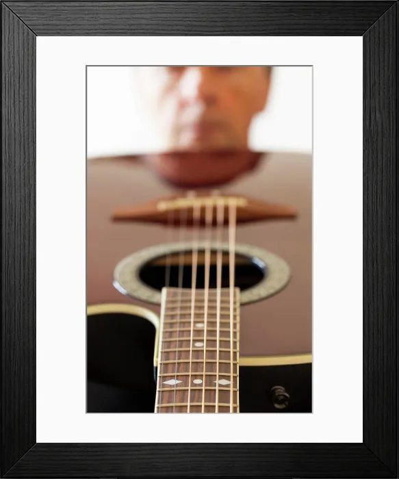Framed Print : View down the fretboard of guitar to face Macro shot down the fretboard of acoustic guitar with shallow depth of field Framed Print : View down the fretboard of guitar to face Macro shot down the fretboard of acoustic guitar with shallow depth of field