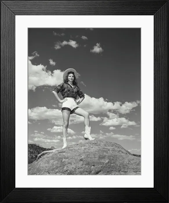 Framed Print : Vintage photograph. Girl hiking, in cowgirl outfit