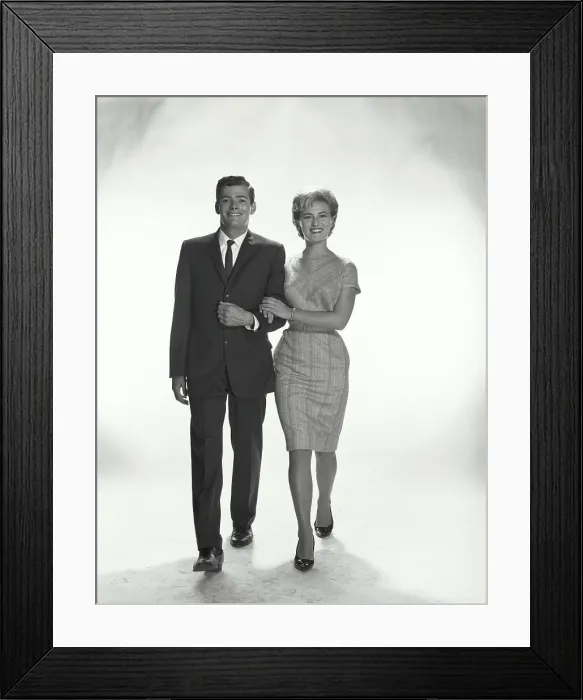 Framed Print : Vintage Photograph. A couple with linked arms walking and smiling in studio Framed Print : Vintage Photograph. A couple with linked arms walking and smiling in studio