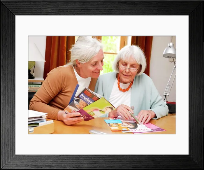 Framed Print : Elderly woman reading information leaflet Framed Print : Elderly woman reading information leaflet