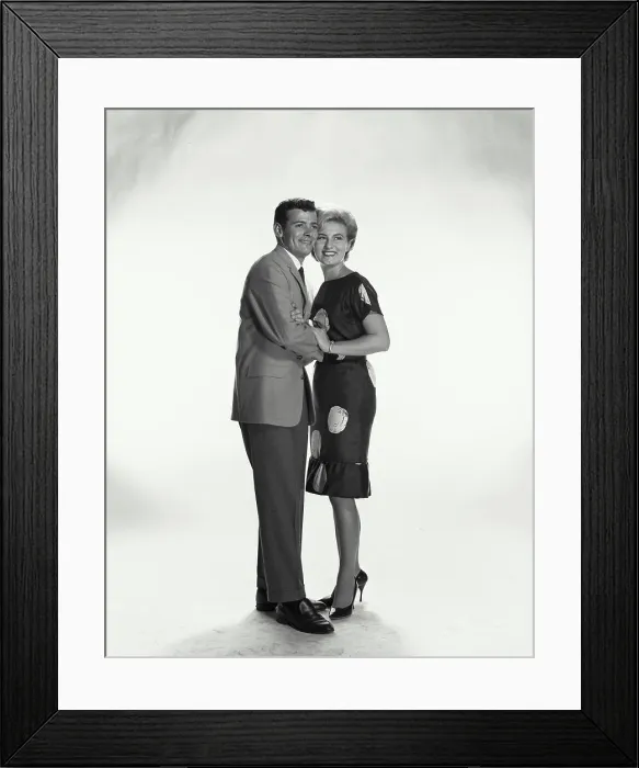 Framed Print : Vintage Photograph. A couple holding each other smiling looking to the left of frame Framed Print : Vintage Photograph. A couple holding each other smiling looking to the left of frame