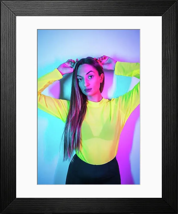 Framed Print : Party lifestyle in a nightclub with pink blue neon lights, portrait of a young blonde caucasian girl in a yellow t-shirt Framed Print : Party lifestyle in a nightclub with pink blue neon lights, portrait of a young blonde caucasian girl in a yellow t-shirt
