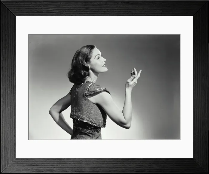 Framed Print : Vintage Photograph. Woman in vest holding up hand and smiling. Frame 2