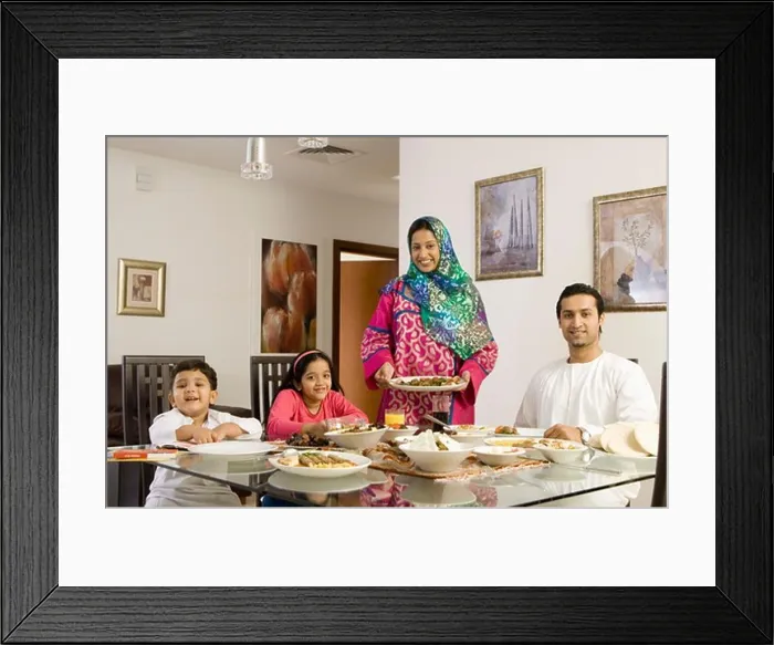 Framed Print : Arab Family looking at camera while dining Framed Print : Arab Family looking at camera while dining