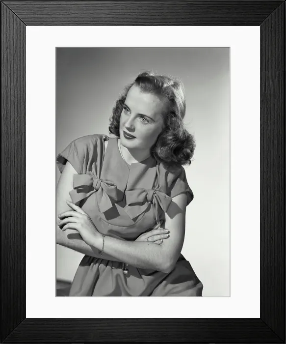 Framed Print : Young woman crossing arms wearing dress with bows on chest Framed Print : Young woman crossing arms wearing dress with bows on chest