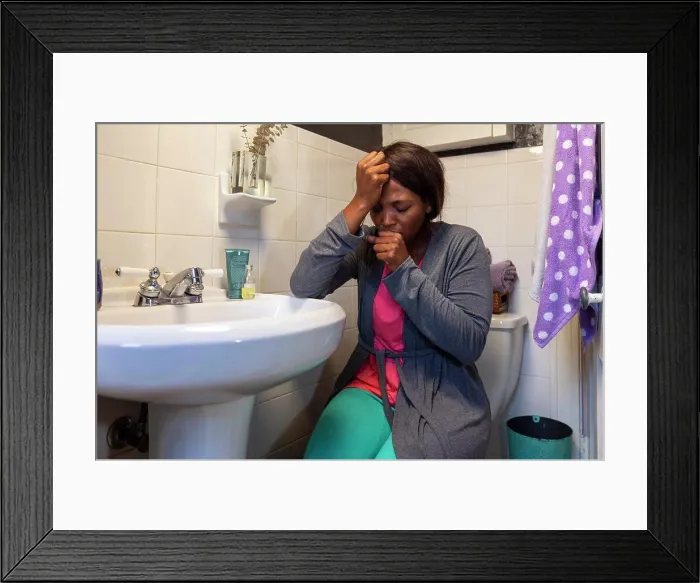Framed Print : Young coughing woman in the bathroom feeling ill Framed Print : Young coughing woman in the bathroom feeling ill