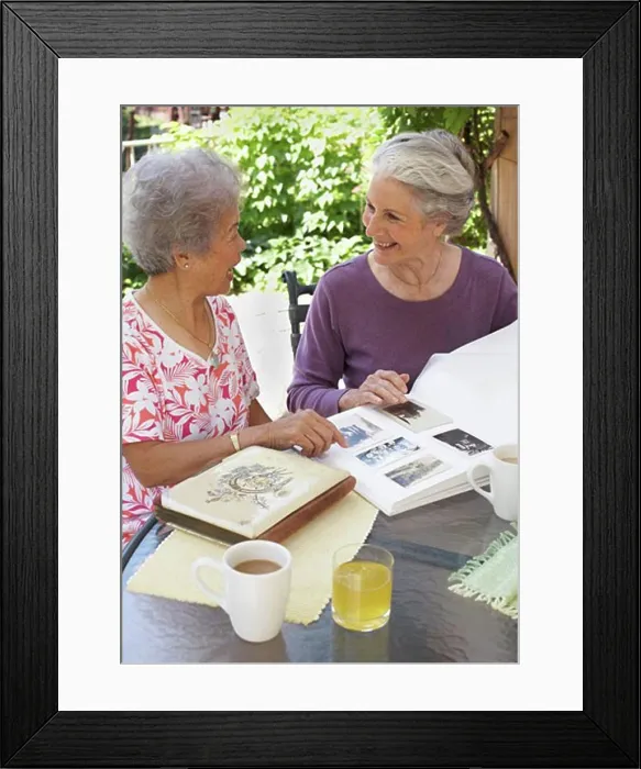 Framed Print : Women Looking at Photographs Framed Print : Women Looking at Photographs