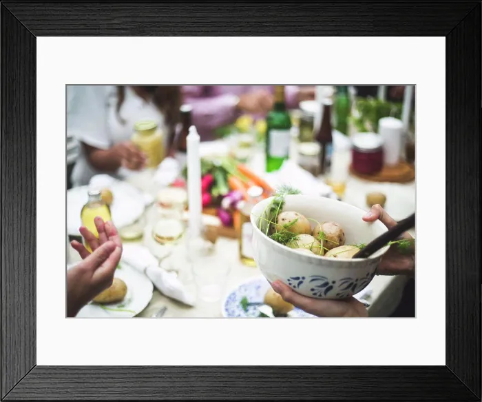 Framed Print : Cropped image of woman holding boiled potatoes bowl at dining table during dinner party Framed Print : Cropped image of woman holding boiled potatoes bowl at dining table during dinner party