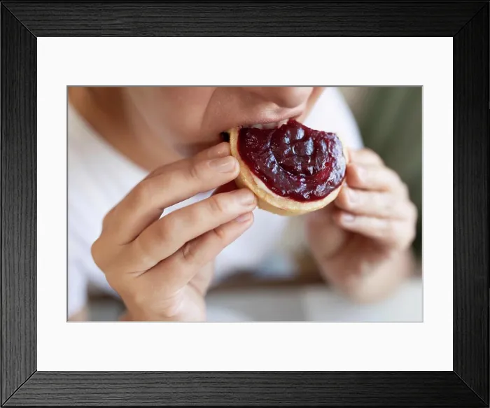 Framed Print : a young woman overeats on sweets while on a diet Framed Print : a young woman overeats on sweets while on a diet