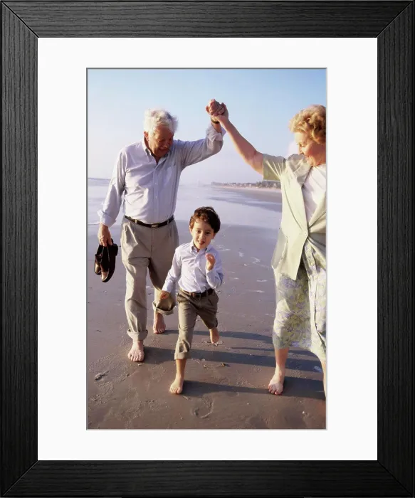 Framed Print : Grandson running at the beach with his grandparents Framed Print : Grandson running at the beach with his grandparents