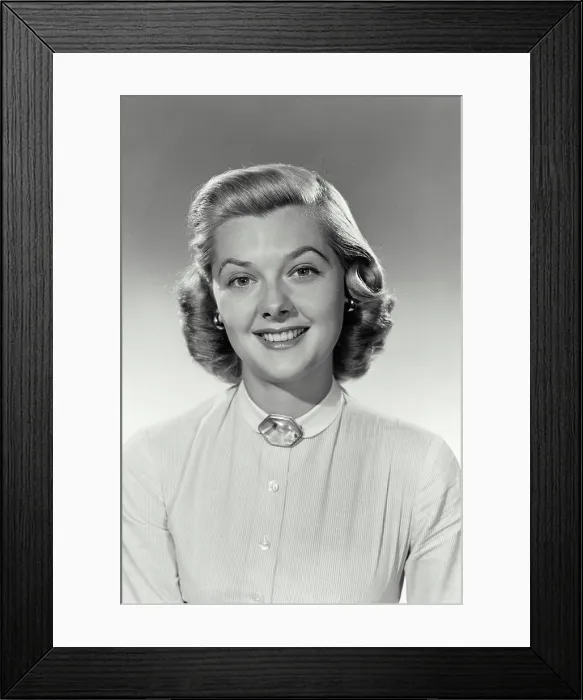 Framed Print : Vintage Photograph. Woman sits smiling for studio portrait with a white shirt on with a jewel at the top Framed Print : Vintage Photograph. Woman sits smiling for studio portrait with a white shirt on with a jewel at the top