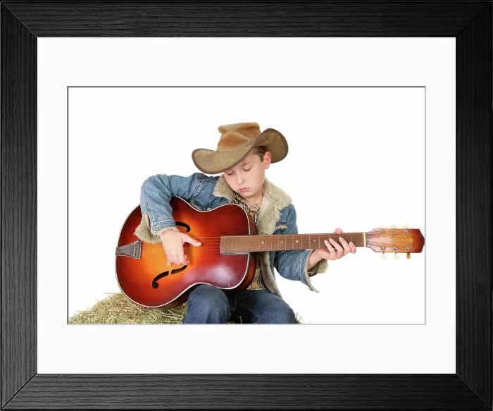 Framed Print : Boy strumming guitar A boy strums a tune on an acoustic guitar Framed Print : Boy strumming guitar A boy strums a tune on an acoustic guitar