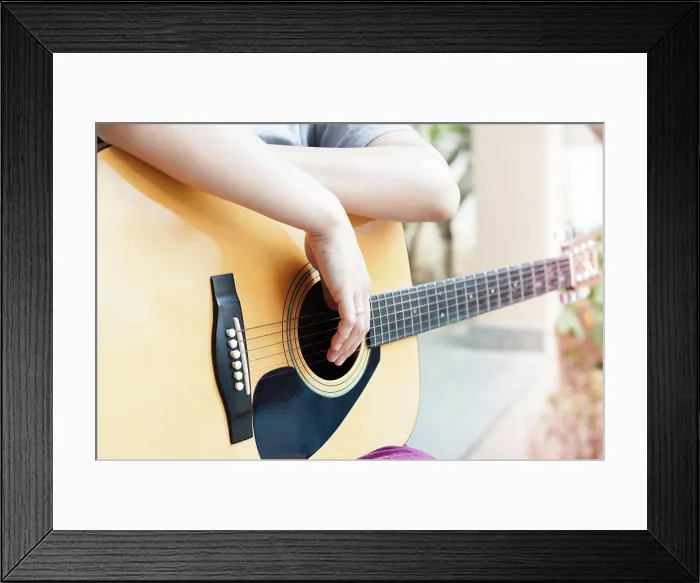 Framed Print : Woman's hands with acoustic guitar in relax post Framed Print : Woman's hands with acoustic guitar in relax post