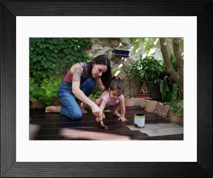 Framed Print : mother and daughter enjoy painting the wood floor together Framed Print : mother and daughter enjoy painting the wood floor together