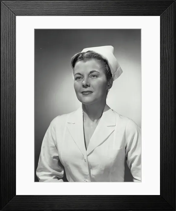 Framed Print : Vintage photograph. Portrait of woman in nurse uniform looking off camera Framed Print : Vintage photograph. Portrait of woman in nurse uniform looking off camera