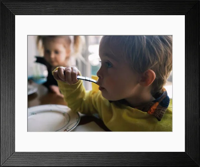 Framed Print : Two young friends eating dinner together