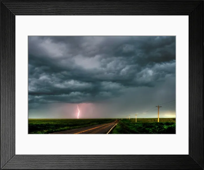 Framed Print : Storm with lightning flashing over highway in rural southern Manitoba Canada
