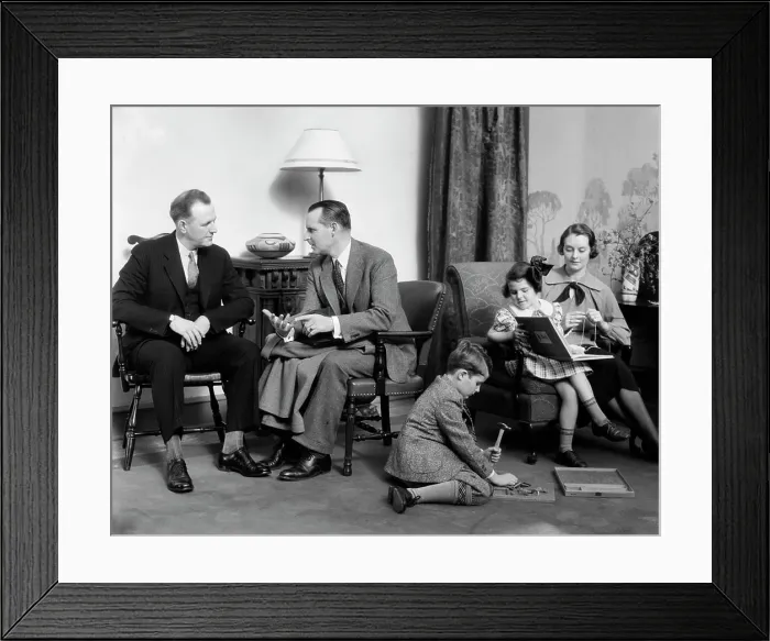 Framed Print : 1930S Family In Living Room Mother Knits Daughter On Her Lap With Book Son On Floor With Hammer