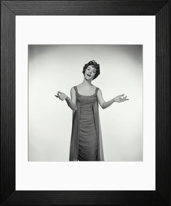 Framed Print : Vintage Photograph. Woman in studio portrait has her hands up to her sides while she sings