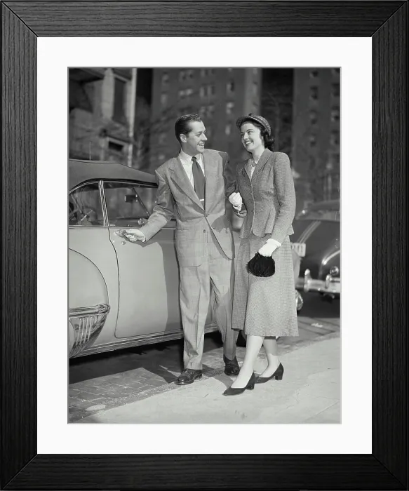 Framed Print : Vintage photograph. Man opening car door for his date Framed Print : Vintage photograph. Man opening car door for his date