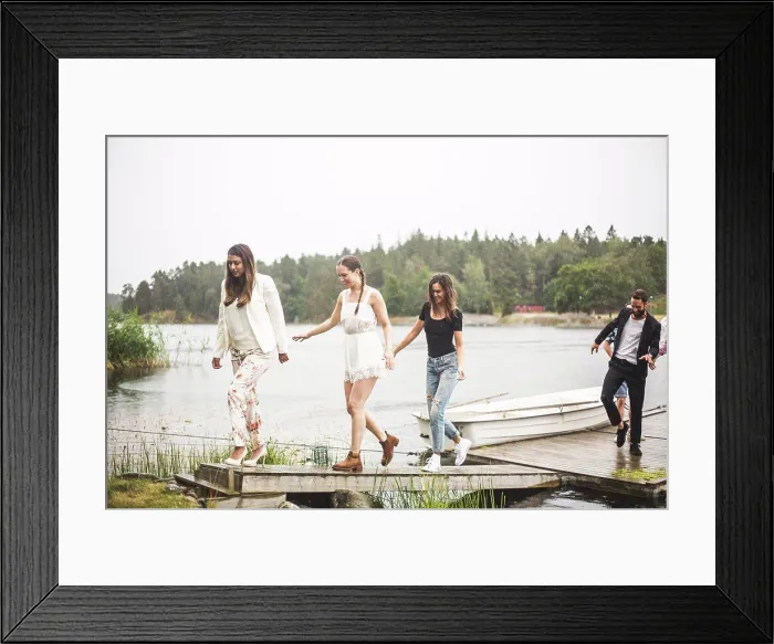 Framed Print : Multi-ethnic friends walking on jetty over lake during weekend getaway Framed Print : Multi-ethnic friends walking on jetty over lake during weekend getaway