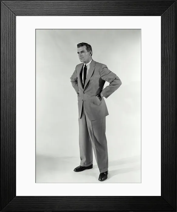 Framed Print : Vintage Photograph. A man standing with hands on his hips with a stern expression