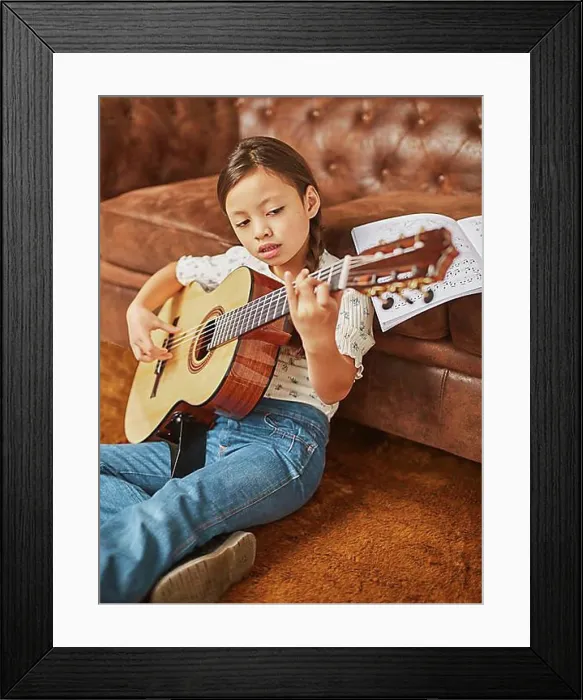 Framed Print : Girl learning how play guitar home