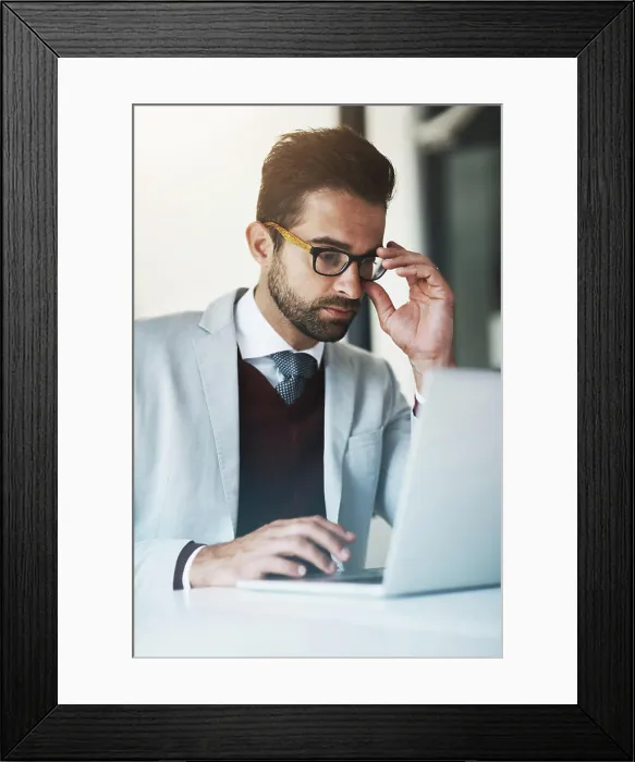 Framed Print : Business man, reading and laptop in office for compliance Framed Print : Business man, reading and laptop in office for compliance