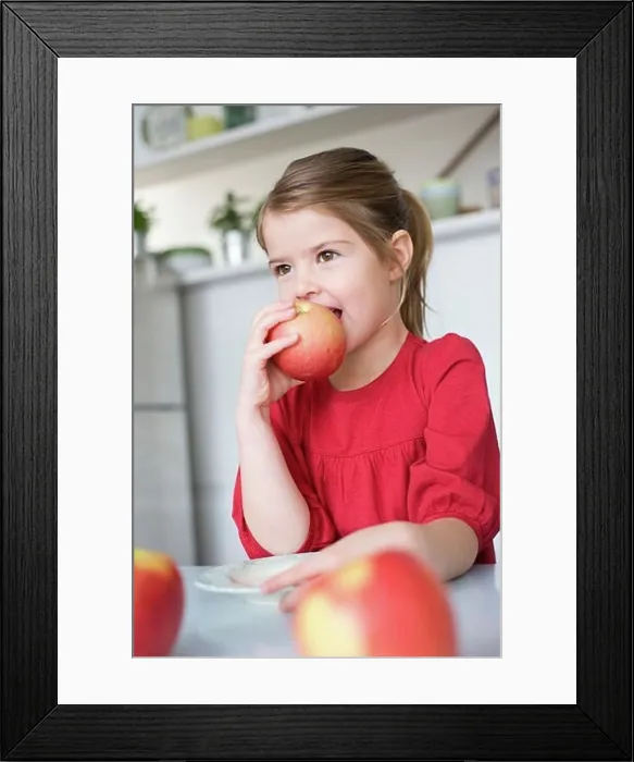 Framed Print : Girl eating an apple Framed Print : Girl eating an apple
