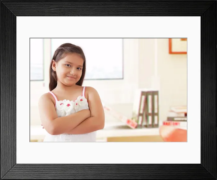 Framed Print : Portrait of smiling girl standing with arms crossed Framed Print : Portrait of smiling girl standing with arms crossed