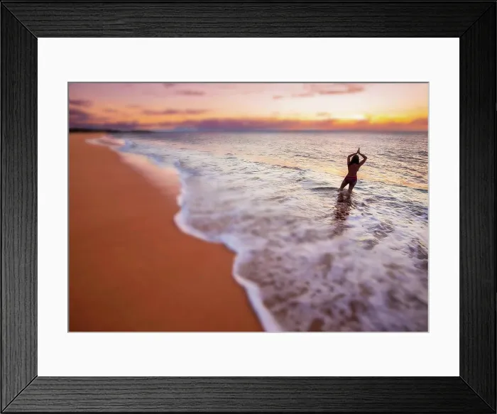 Framed Print : A blurred image of a woman standing in the surf Framed Print : A blurred image of a woman standing in the surf