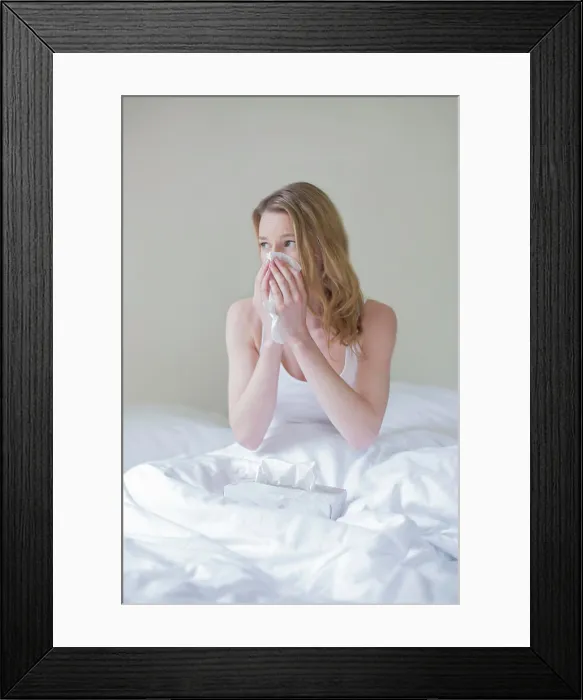 Framed Print : Woman sick with handkerschiefs in bed