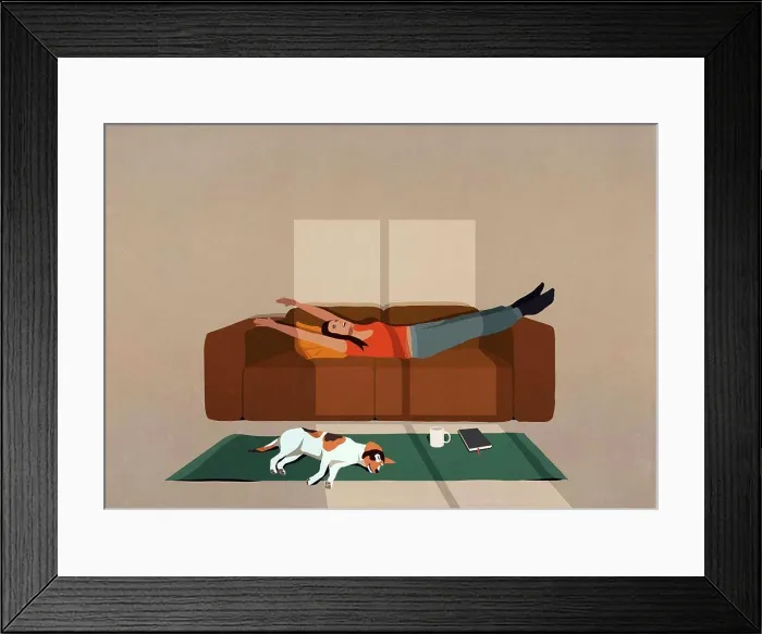Framed Print : Carefree woman stretching on sofa in sunny living room Framed Print : Carefree woman stretching on sofa in sunny living room