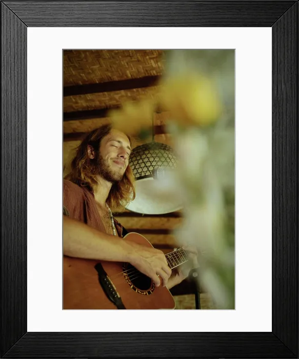 Framed Print : Young man musician plays the guitar and sings into a microphone Framed Print : Young man musician plays the guitar and sings into a microphone