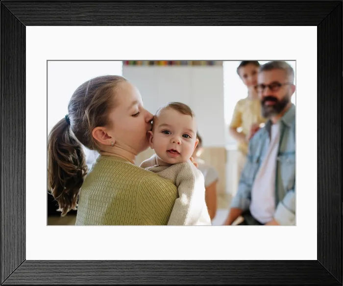 Framed Print : Big sister holding small little brother in her arms Framed Print : Big sister holding small little brother in her arms