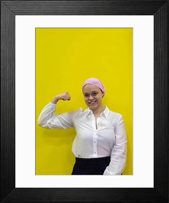 Framed Print : Medical and health concept. Healthy woman showing her fist of power against female cancer in the yellow background Framed Print : Medical and health concept. Healthy woman showing her fist of power against female cancer in the yellow background