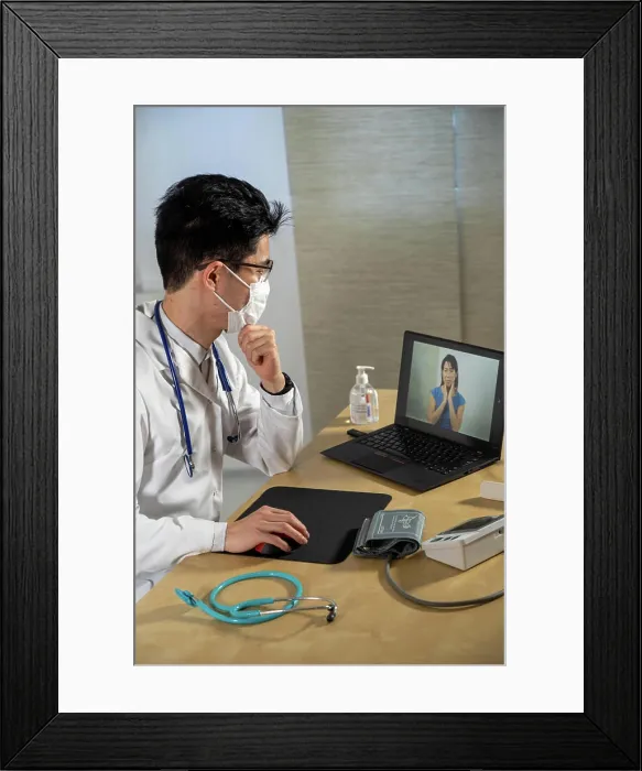 Framed Print : Doctor in remote consultation with 30 year old female patient with pain in her throat