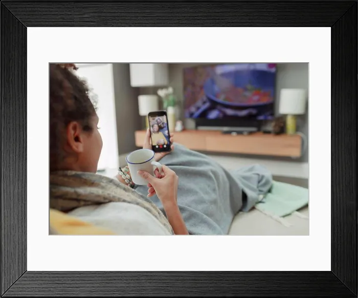 Framed Print : Woman with tea video chatting with parents on smart phone screen Framed Print : Woman with tea video chatting with parents on smart phone screen