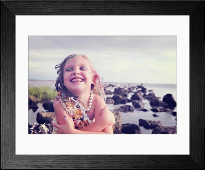 Framed Print : Girl laughing joyfully by the sea with colorful hair and pearls
