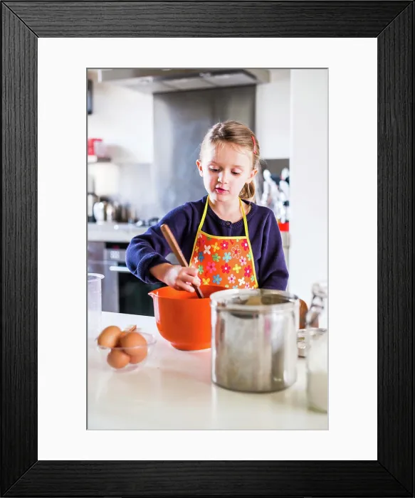 Framed Print : 5 year-old girl learning cooking Framed Print : 5 year-old girl learning cooking