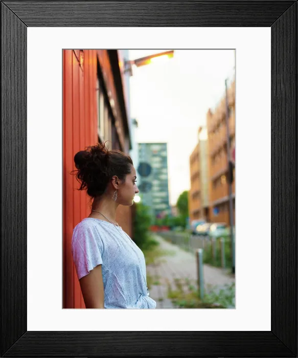 Framed Print : Expressive playful girl posing on red Framed Print : Expressive playful girl posing on red