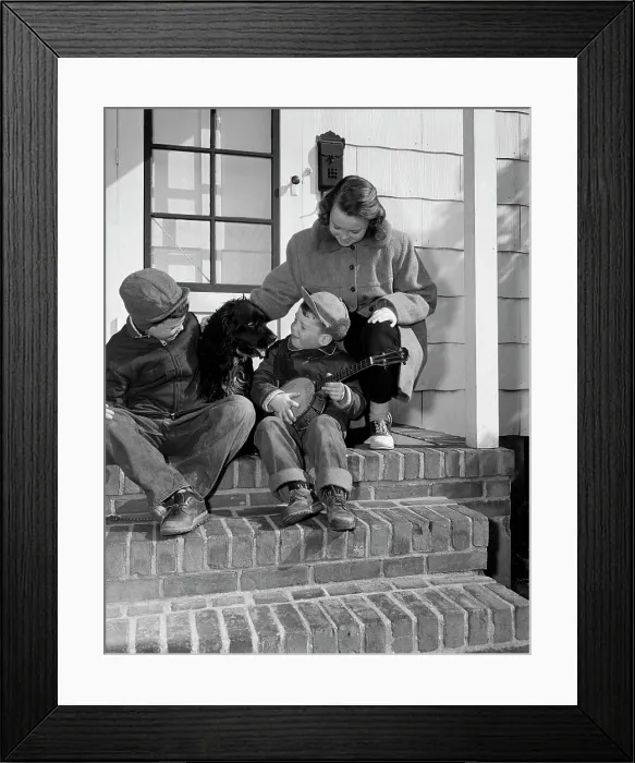 Framed Print : Children sitting with dog on steps
