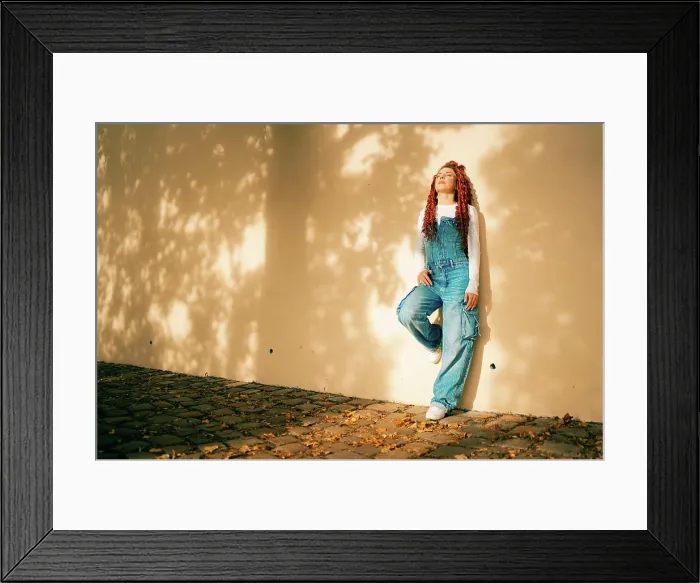 Framed Print : Young woman relaxing near a shady wall in Prague Framed Print : Young woman relaxing near a shady wall in Prague