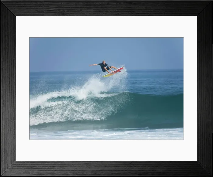 Framed Print : A young man performing an aerial maneuver at Rocky Point, north shore of Oahu