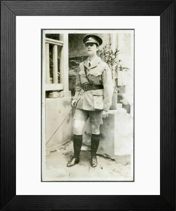 Framed Print : A European woman poses outside a brick-built house dressed up in army uniform and carrying a cane Framed Print : A European woman poses outside a brick-built house dressed up in army uniform and carrying a cane