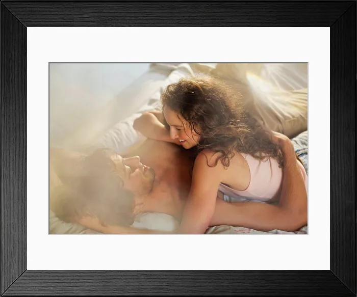 Framed Print : Couple relaxing together in bed Framed Print : Couple relaxing together in bed
