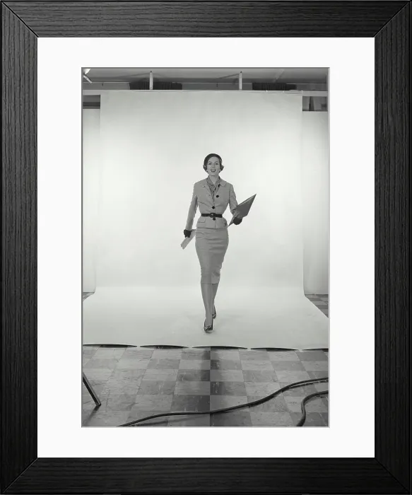 Framed Print : Vintage Photograph. Full length view of woman wearing light grey skirt and jacket and hat on white studio background Framed Print : Vintage Photograph. Full length view of woman wearing light grey skirt and jacket and hat on white studio background